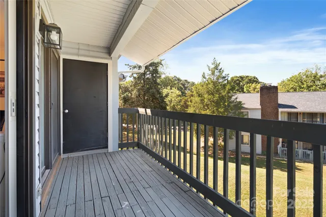 a view of a balcony with wooden floor