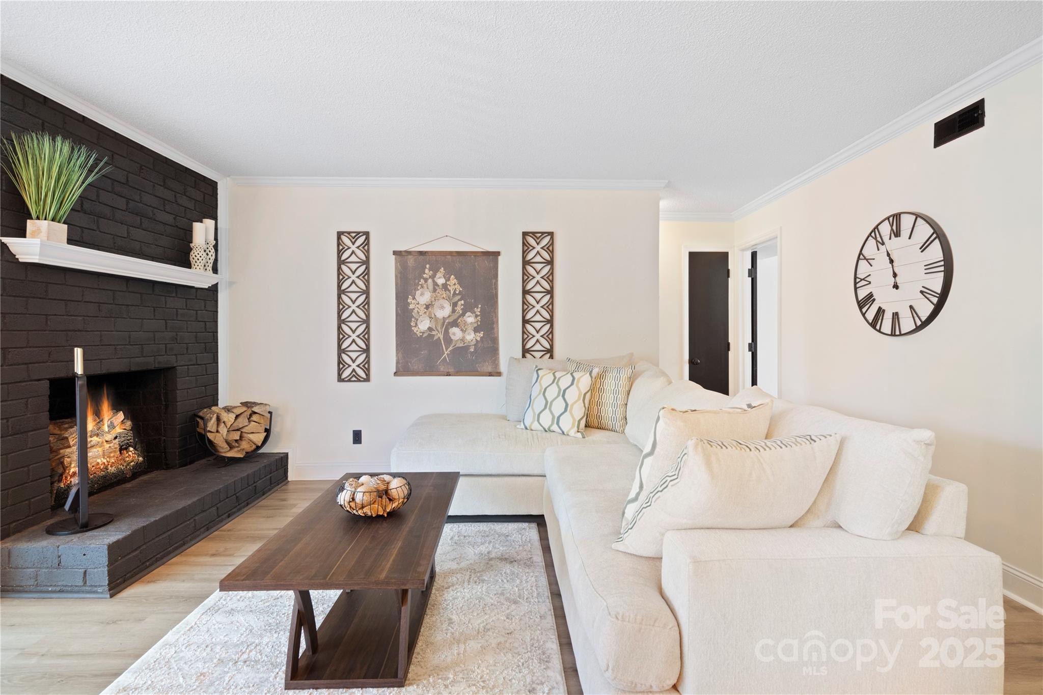 11123 Harrowfield Road Charlotte, NC 28226 - Photo 6 of 20 a living room with furniture a flat screen tv and a fireplace