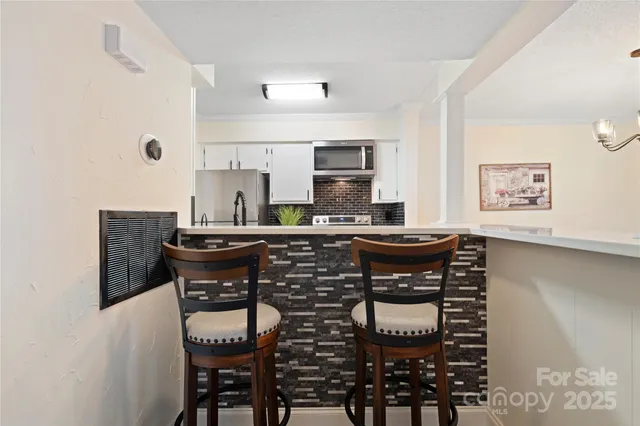 a kitchen with a table and chairs in it