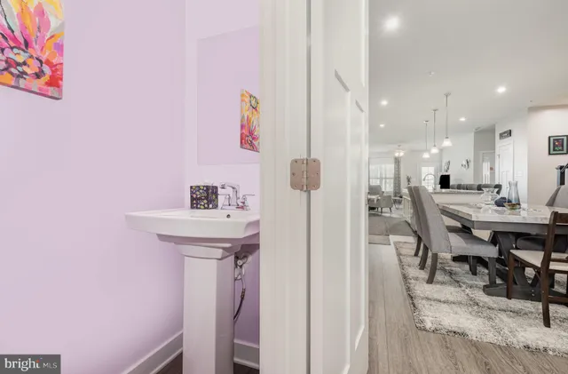 a view of a hallway with furniture and wooden floor