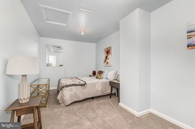 a room with a bed and a lamp on table