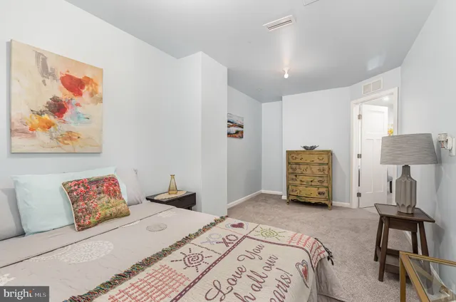 a bedroom with a bed and a lamp