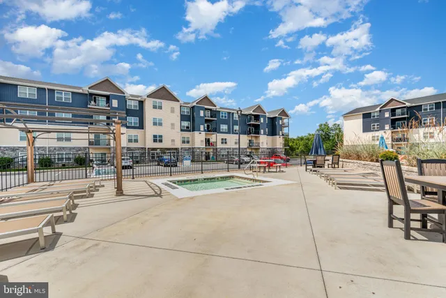 a view of a patio with dining table and chairs with wooden floor