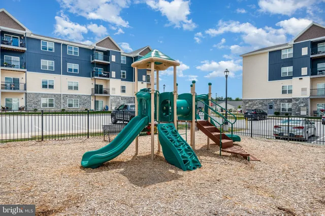a view of a house with swimming pool and sitting area