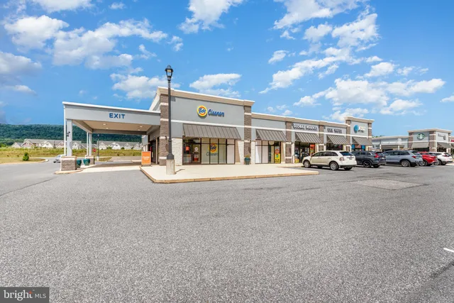 a view of building with car parked