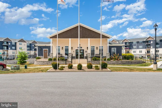 a view of a house with a swimming pool and sitting area