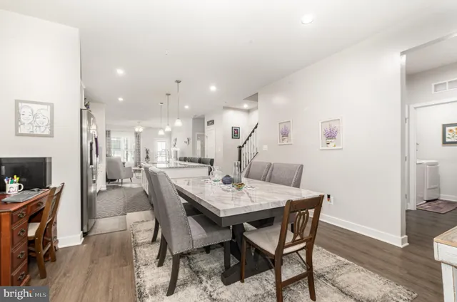 a view of a dining room with furniture and a wooden floor