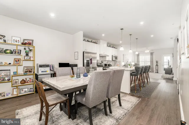 a dining room with kitchen island a table and chairs