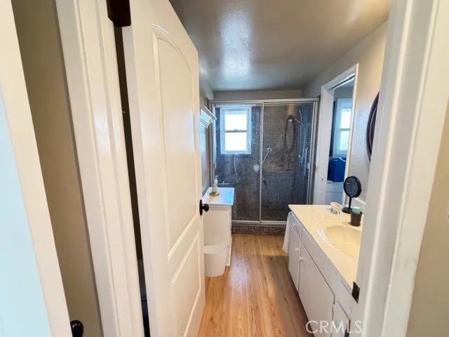a bathroom with sink a mirror a bathtub and shower
