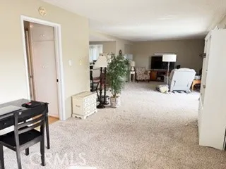 a view of a livingroom with furniture and a flat screen tv