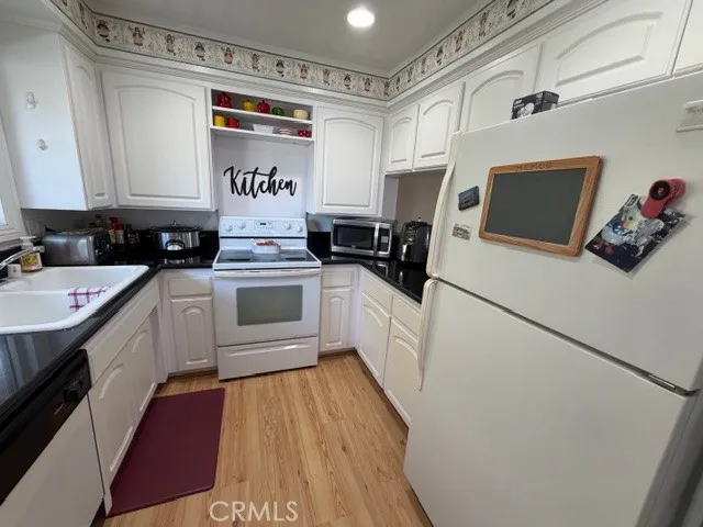 a kitchen with a refrigerator and a stove