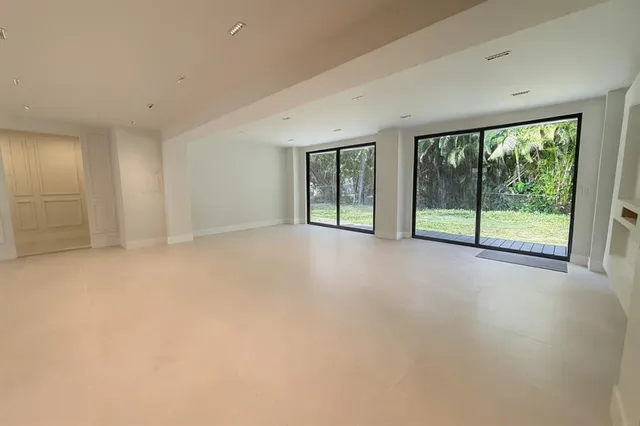 a view of empty room with floor to ceiling window