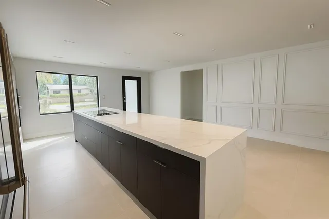 a living room with stainless steel appliances kitchen island sink and faucet