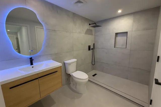 a bathroom with a toilet sink and shower