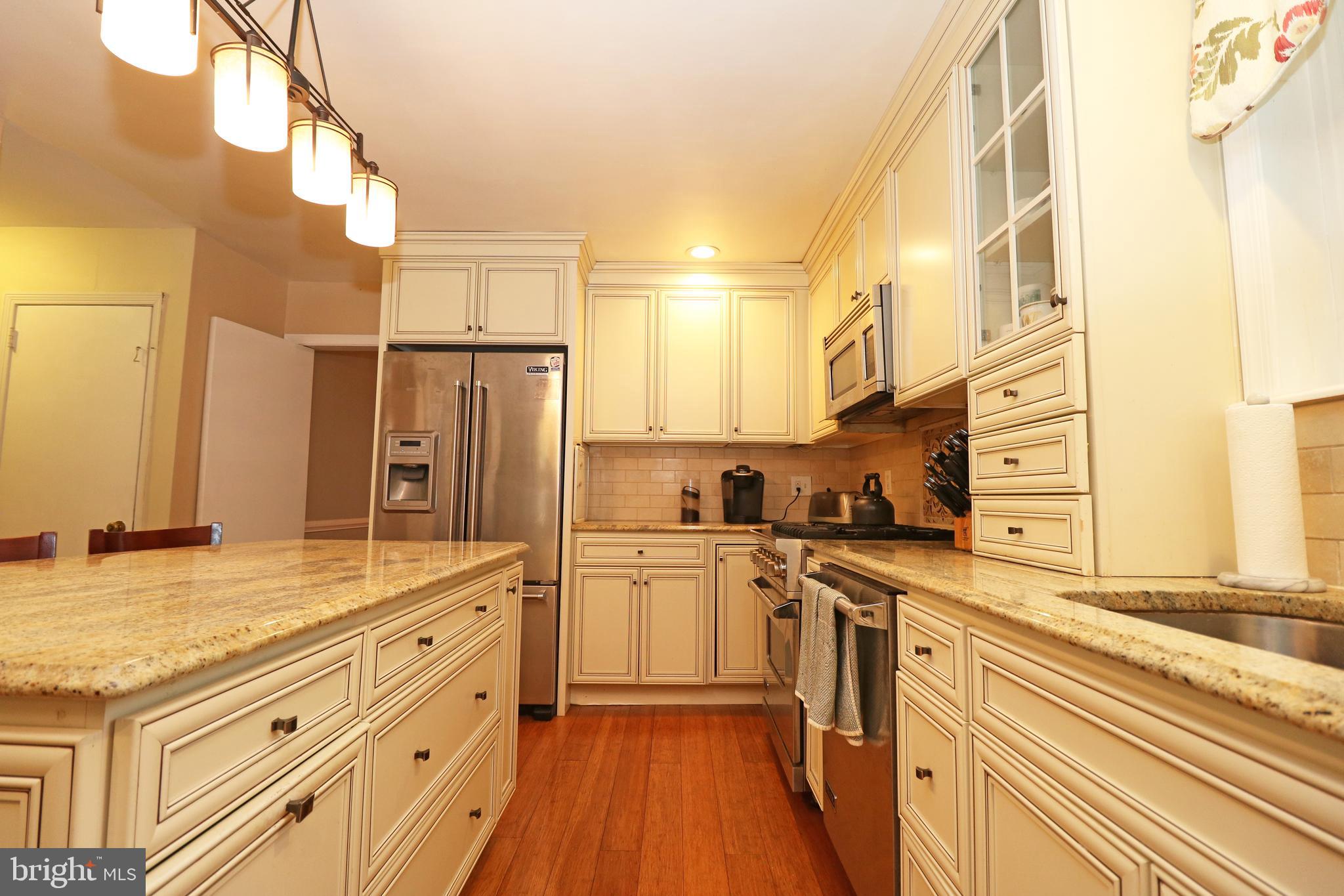 371 Southcroft Road Springfield, PA 19064 - Photo 12 of 42 a kitchen with stainless steel appliances granite countertop a sink a stove and refrigerator