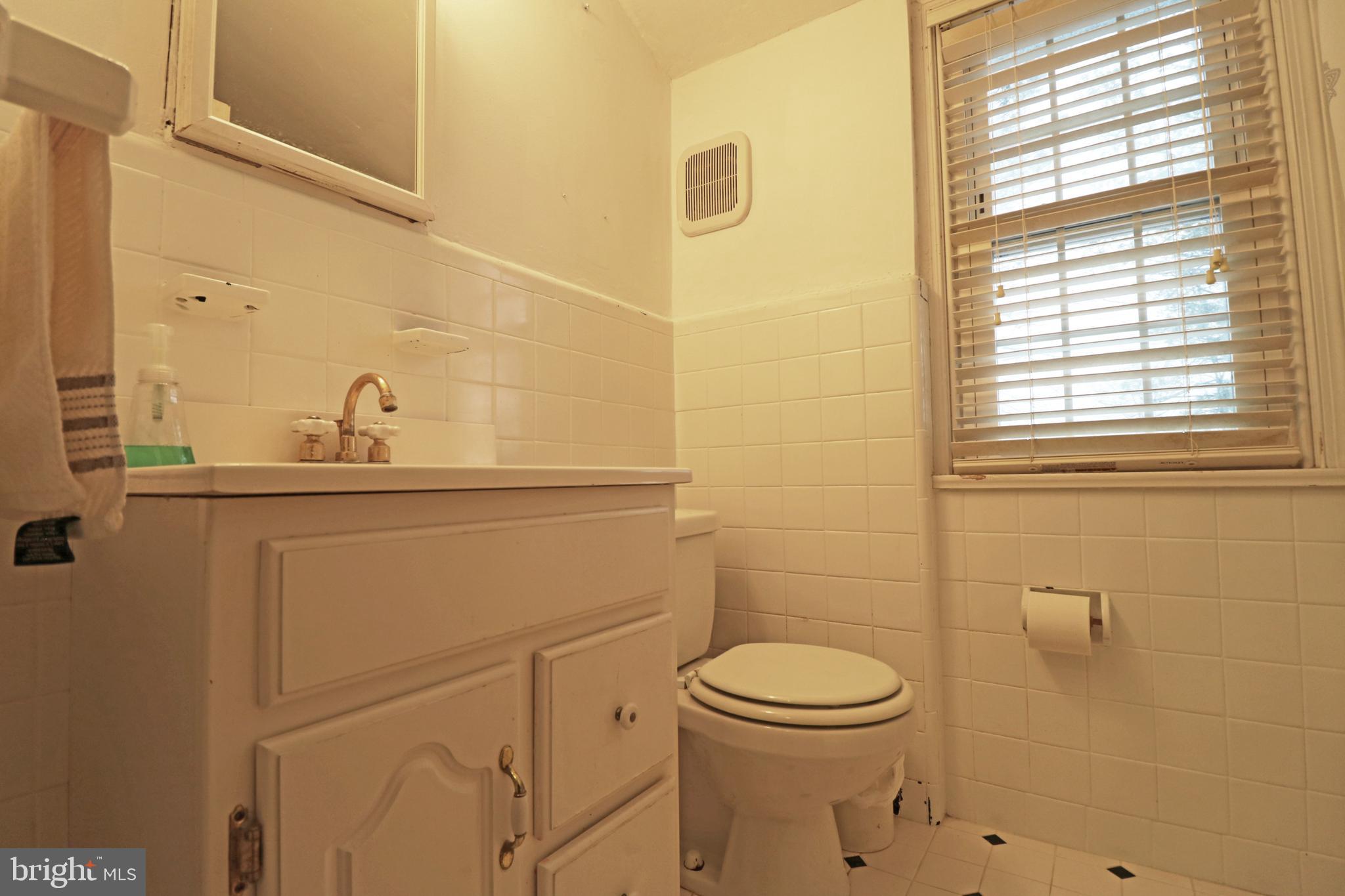 371 Southcroft Road Springfield, PA 19064 - Photo 26 of 42 a bathroom with a sink a toilet and a mirror