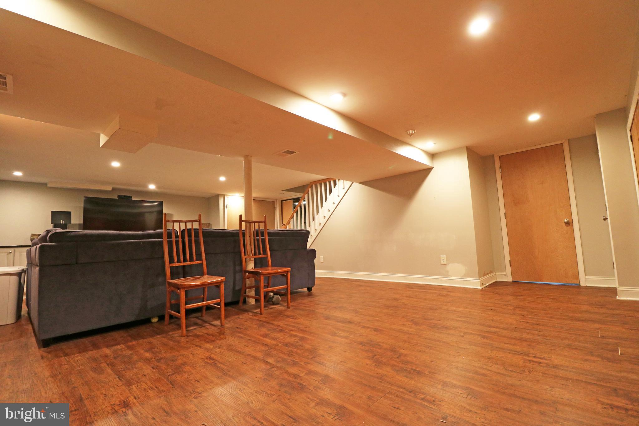 371 Southcroft Road Springfield, PA 19064 - Photo 35 of 42 a view of a big room with wooden floor furniture and a kitchen