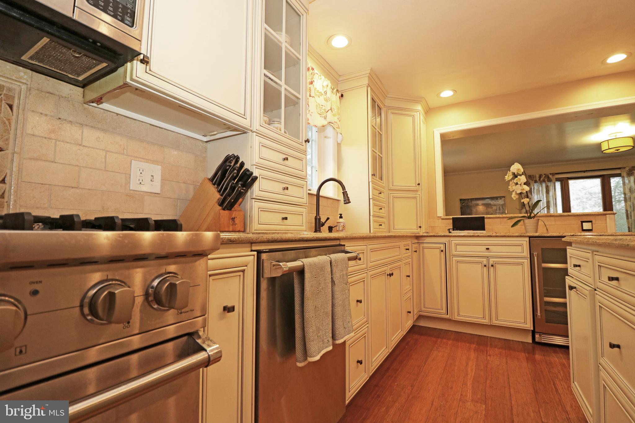 371 Southcroft Road Springfield, PA 19064 - Photo 9 of 42 a kitchen with stainless steel appliances granite countertop a stove and a sink