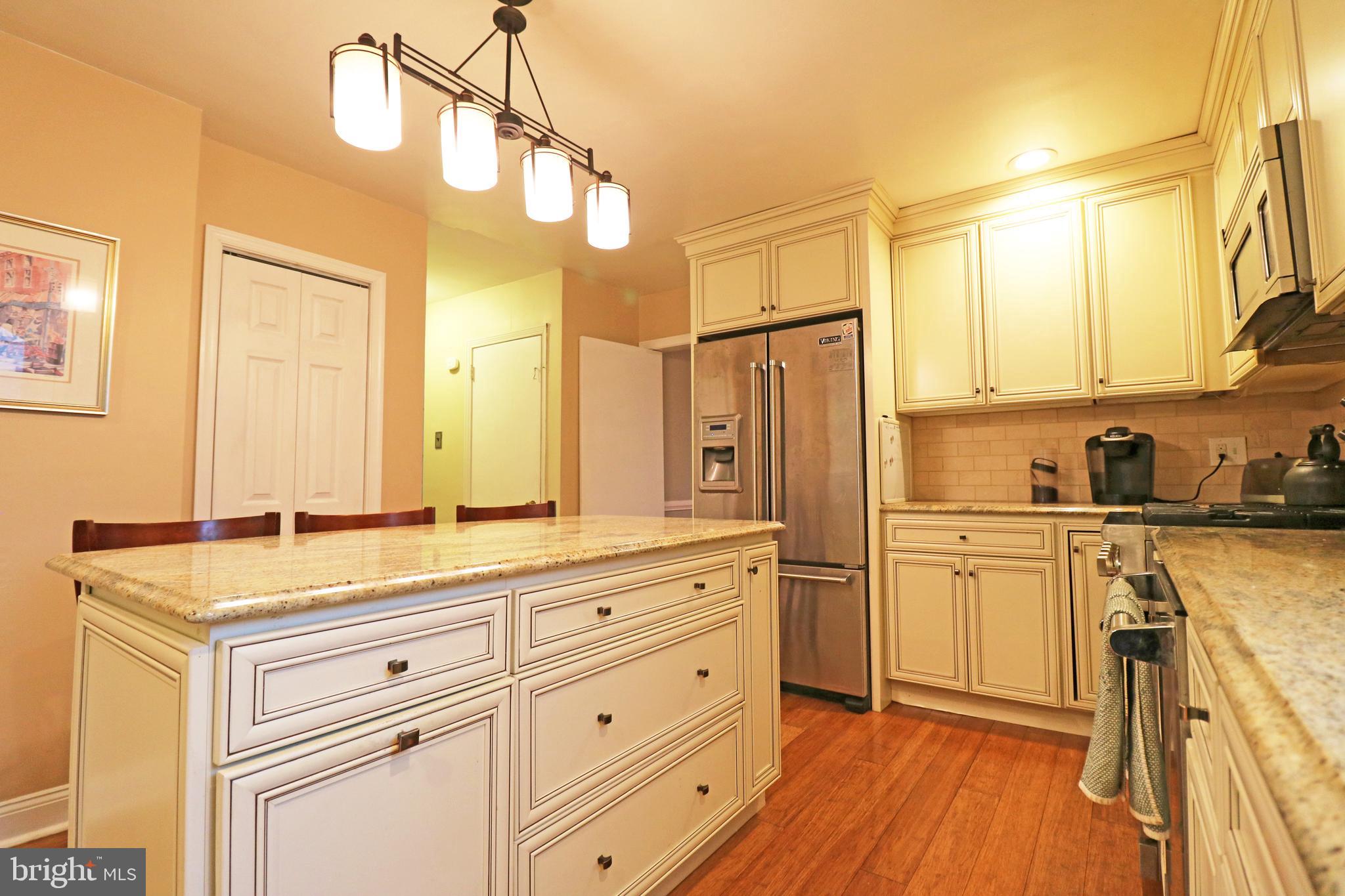 371 Southcroft Road Springfield, PA 19064 - Photo 10 of 42 a kitchen with stainless steel appliances sink cabinets and wooden floor