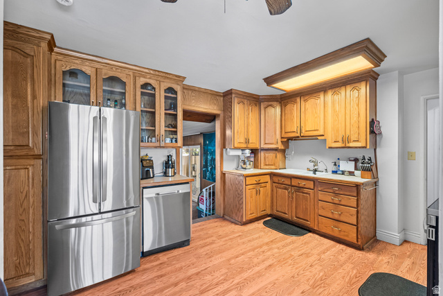 31 B Street Springville, UT 84663 - Photo 6 of 31 Kitchen featuring wood-finish flooring, wood cabinetry with glass-front accents, and stainless steel appliances
