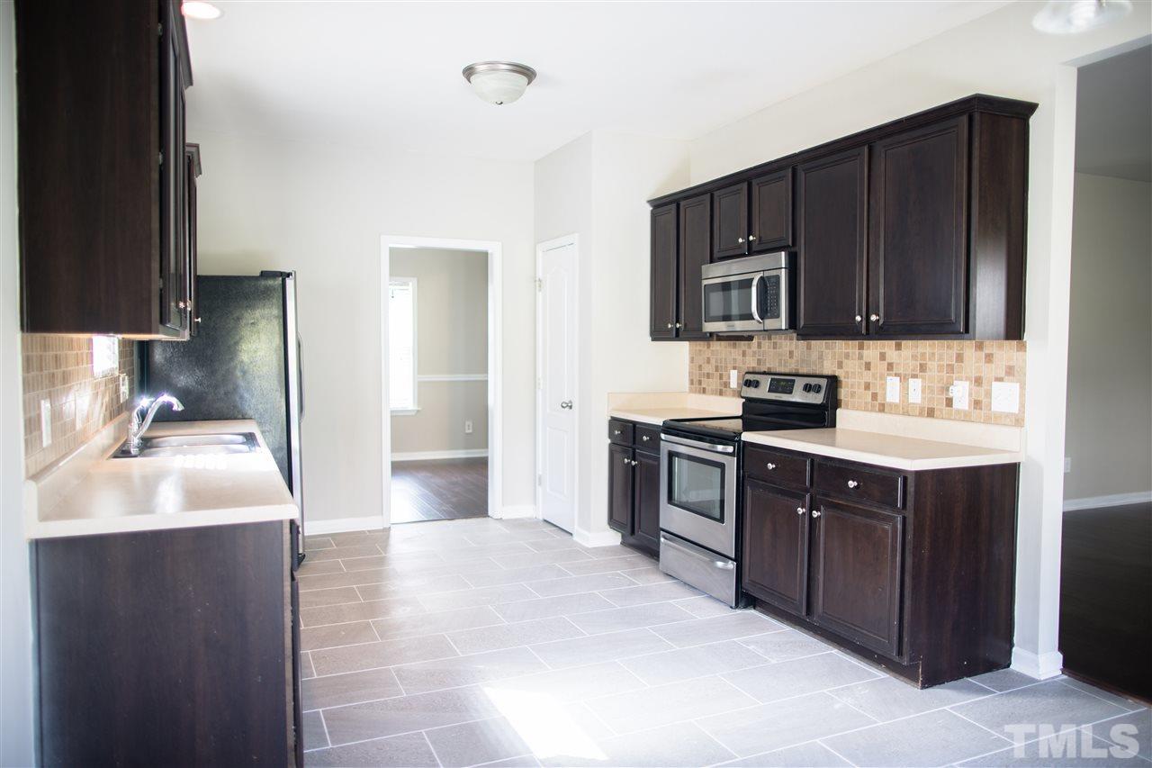 5625 Quitman Trail Raleigh, NC 27610 - Photo 2 of 4 a kitchen with stainless steel appliances granite countertop a sink stove and refrigerator