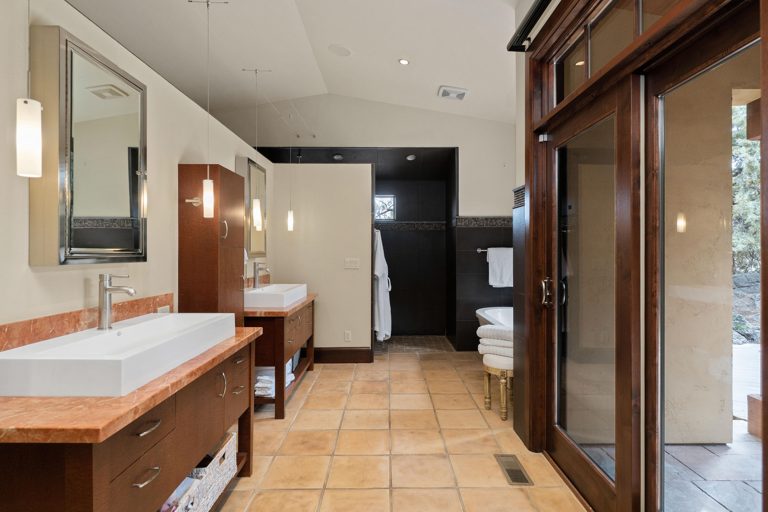 65904 Fazio Ln Bend Bend, OR 97701 - Photo 27 of 63 Elegantly designed with outdoor access, separate vanities, soaking tub, tiled shower, and fabulous walk-in closet.