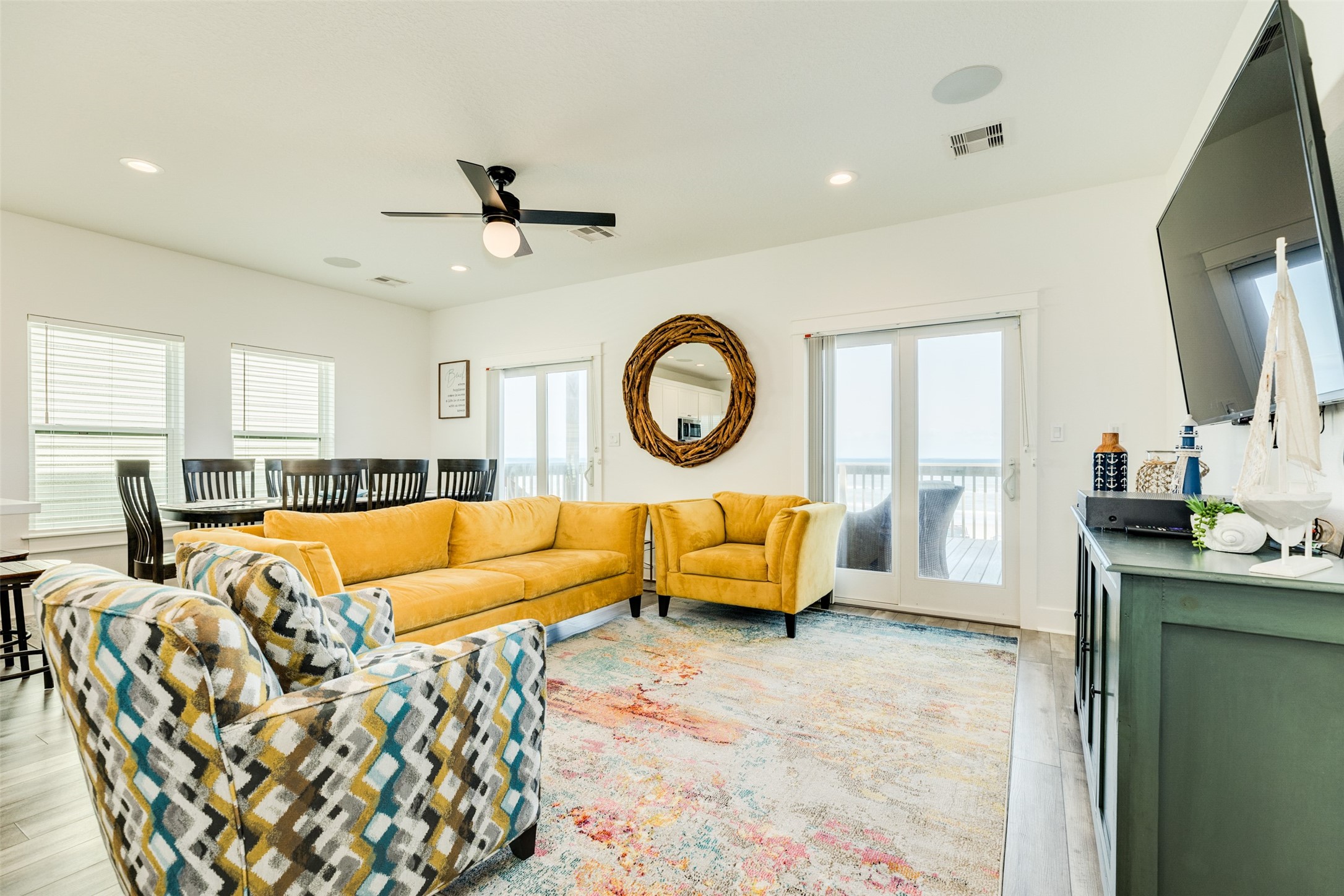 109 D Santar Loop Surfside Beach, TX 77541 - Photo 11 of 42 a living room with furniture a mirror and a flat screen tv