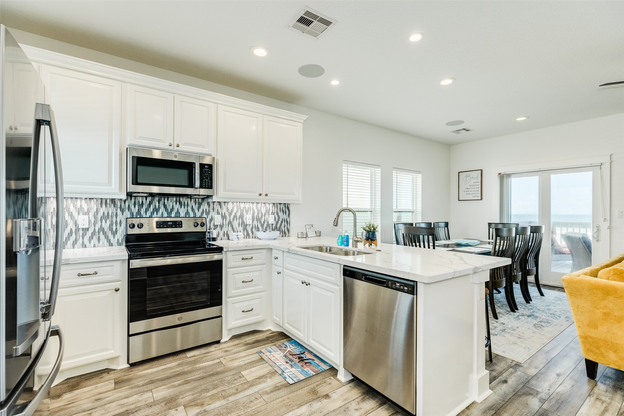 109 D Santar Loop Surfside Beach, TX 77541 - Photo 18 of 42 a kitchen with a sink stove and microwave