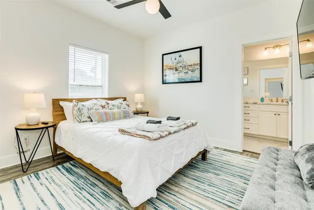 a bathroom with a granite countertop toilet sink and a mirror