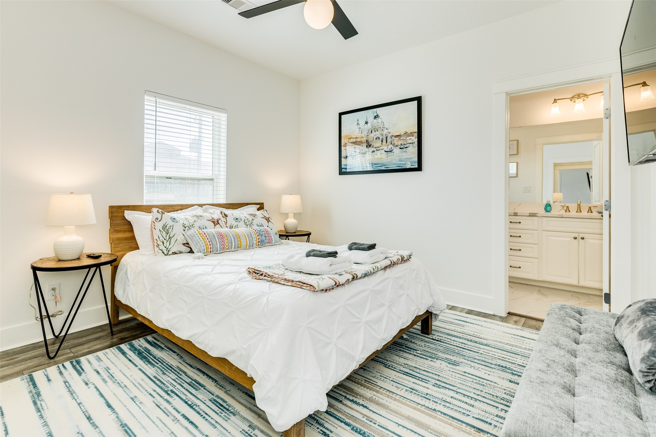 109 D Santar Loop Surfside Beach, TX 77541 - Photo 23 of 42 a bedroom with a bed and wooden floor