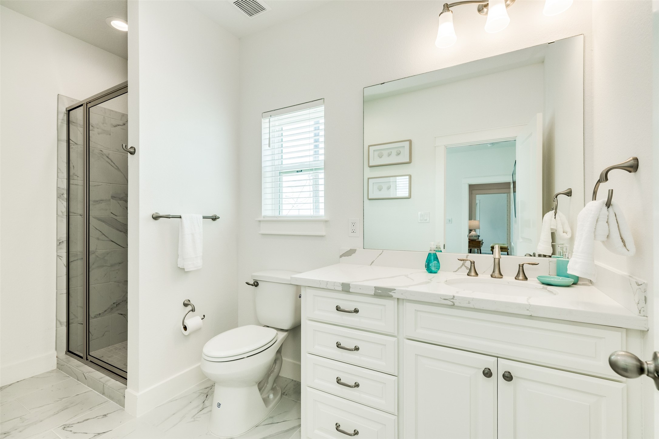 109 D Santar Loop Surfside Beach, TX 77541 - Photo 24 of 42 a bathroom with a granite countertop toilet sink and a mirror