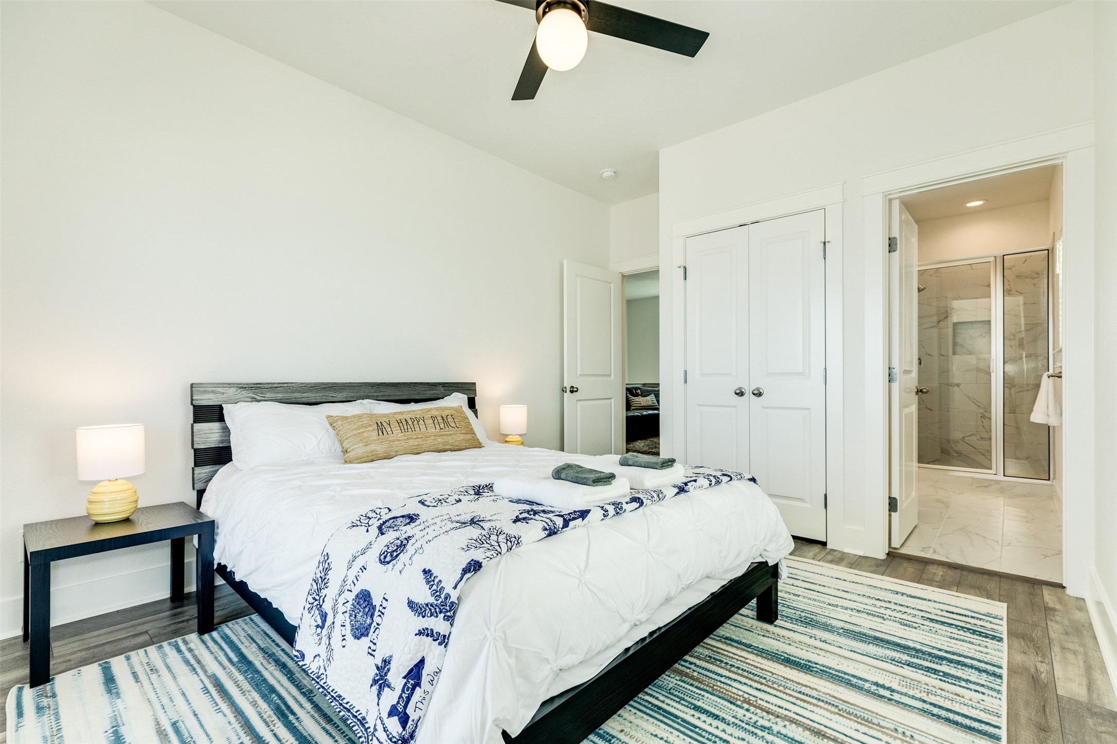 109 D Santar Loop Surfside Beach, TX 77541 - Photo 28 of 42 a bedroom with a bed and wooden floor