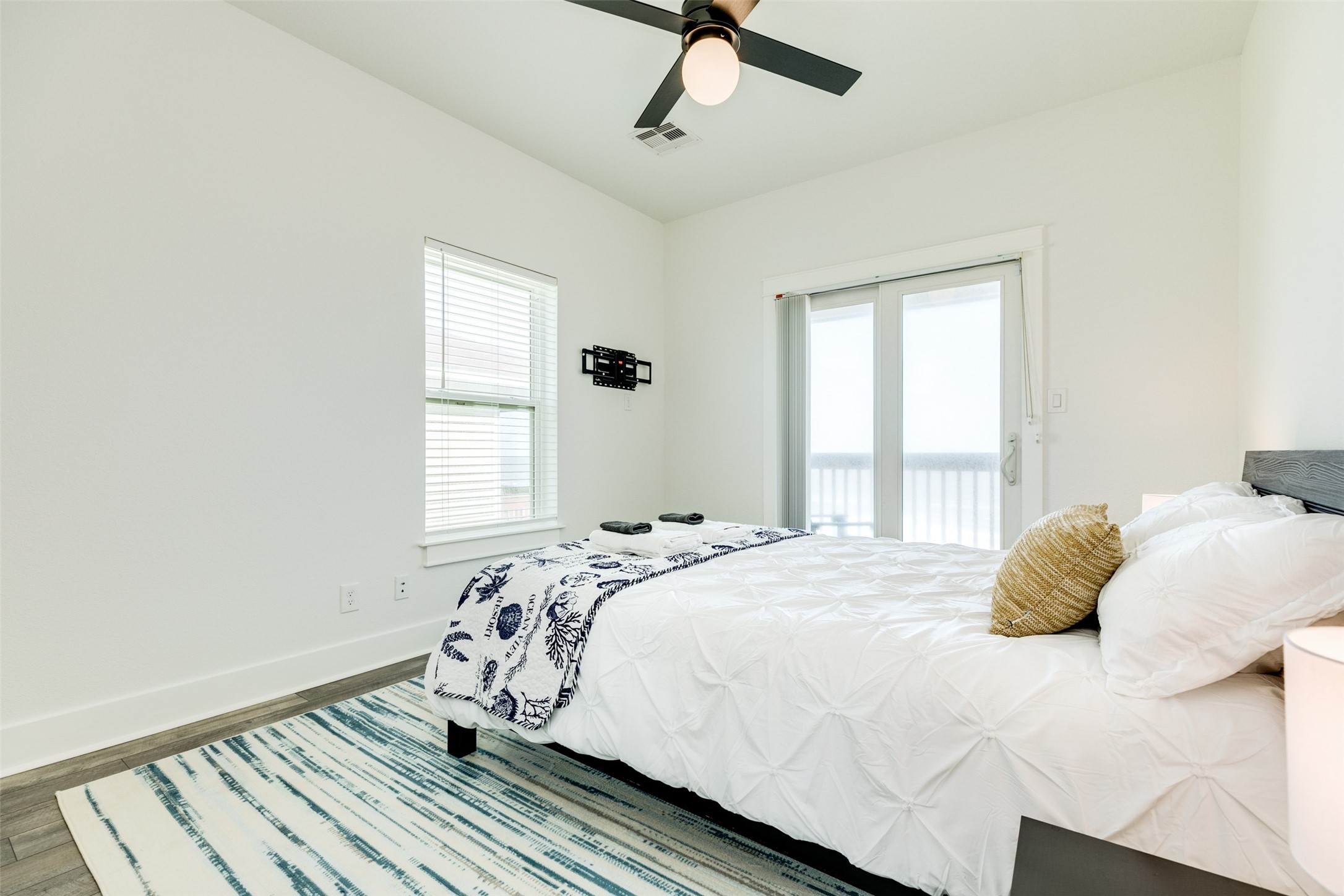 109 D Santar Loop Surfside Beach, TX 77541 - Photo 29 of 42 a bedroom with a bed and wooden floor