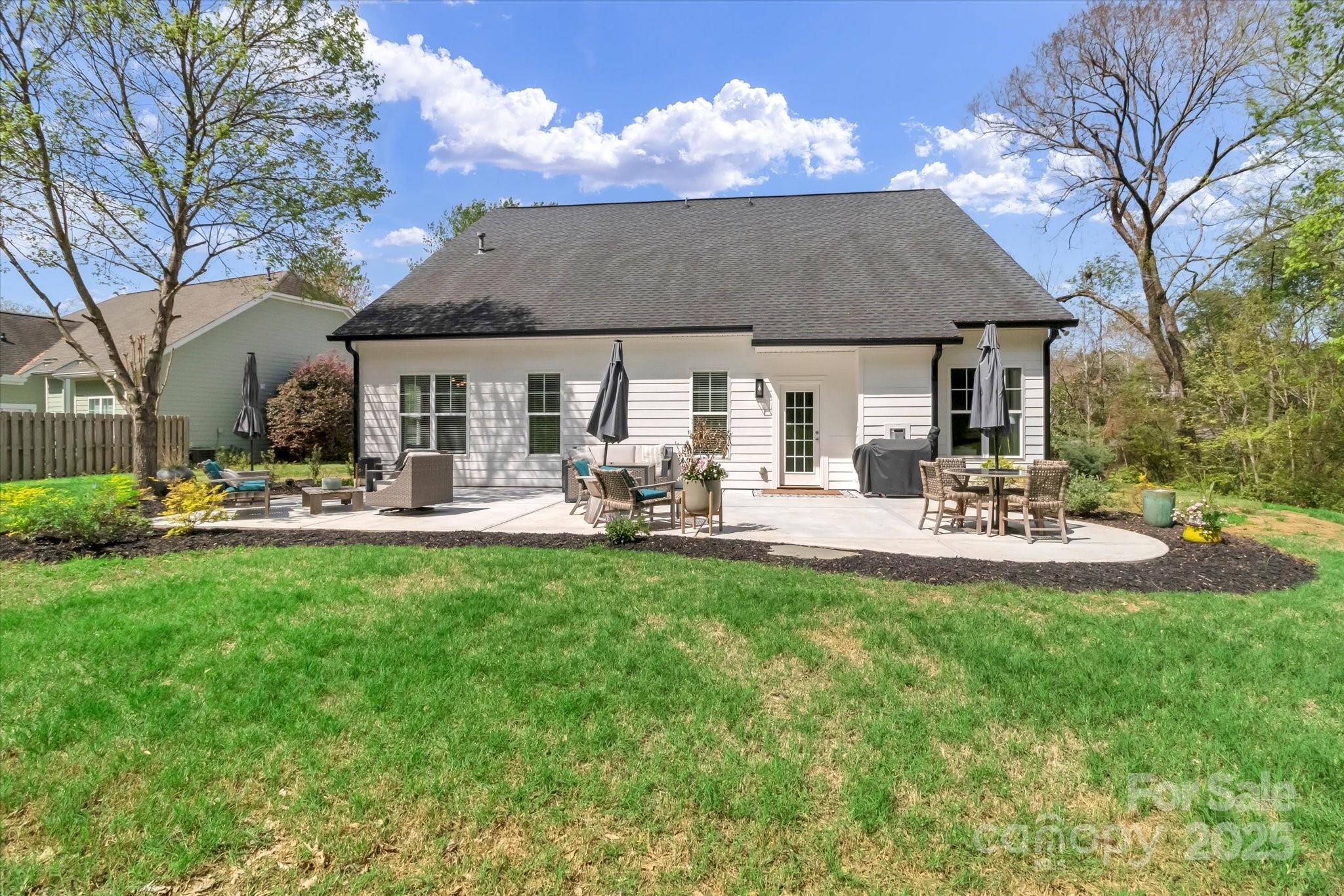 835 Ryans Place Fort Mill, SC 29715 - Photo 36 of 37 a view of a white house with a yard patio and fire pit