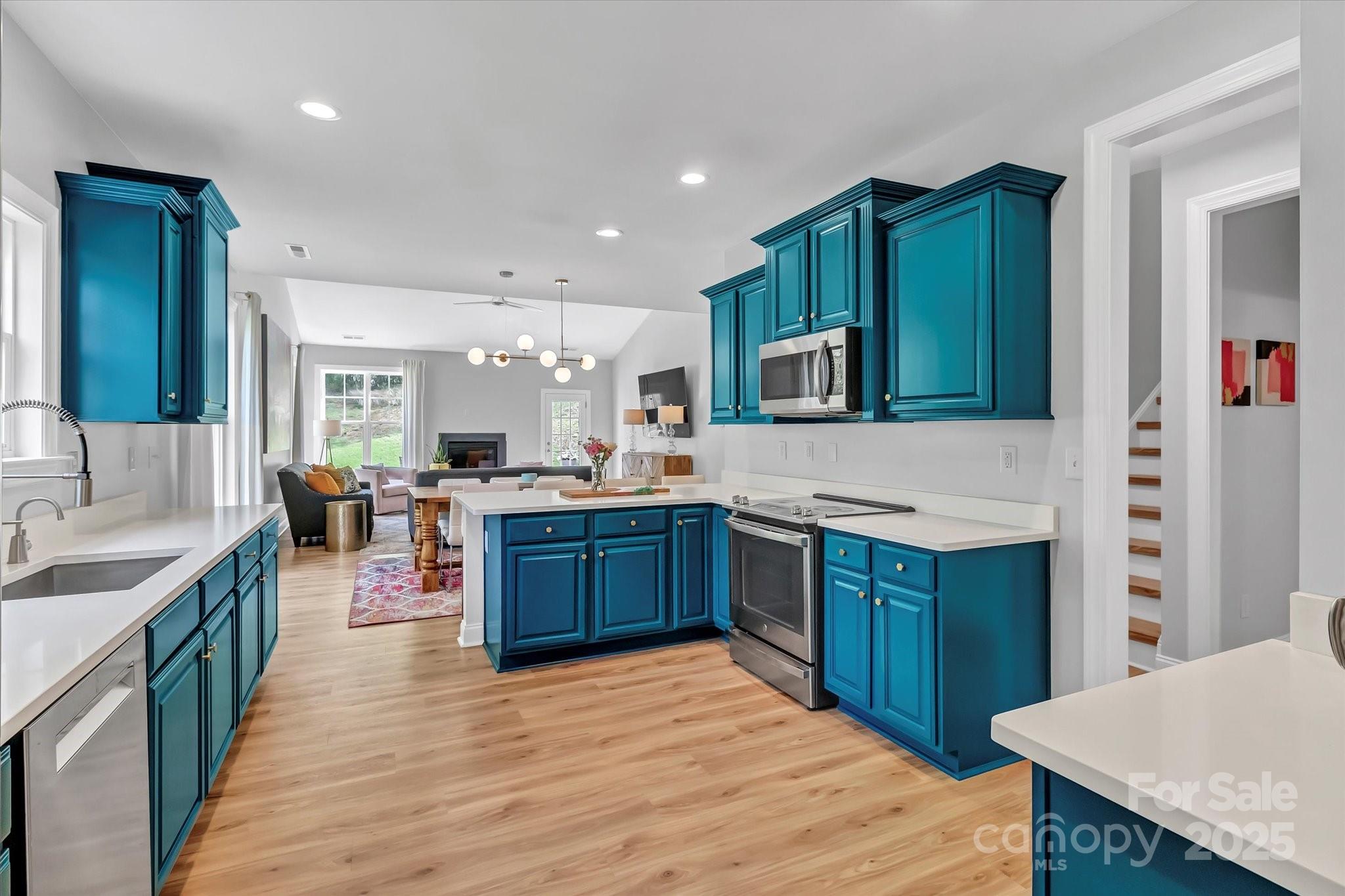 835 Ryans Place Fort Mill, SC 29715 - Photo 6 of 37 a large kitchen with stainless steel appliances wooden floor and wooden cabinets