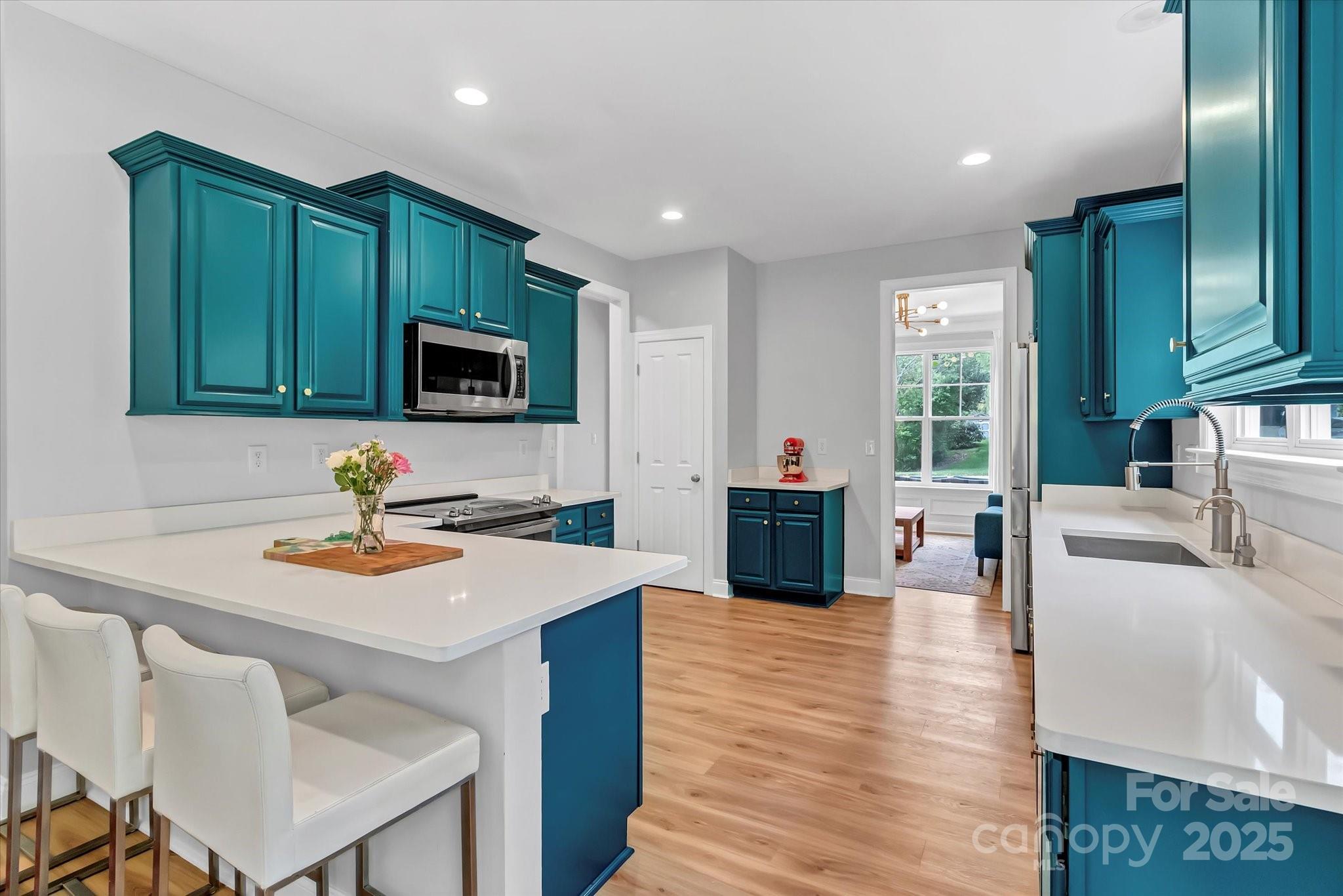 835 Ryans Place Fort Mill, SC 29715 - Photo 7 of 37 a kitchen with sink cabinets and wooden floor