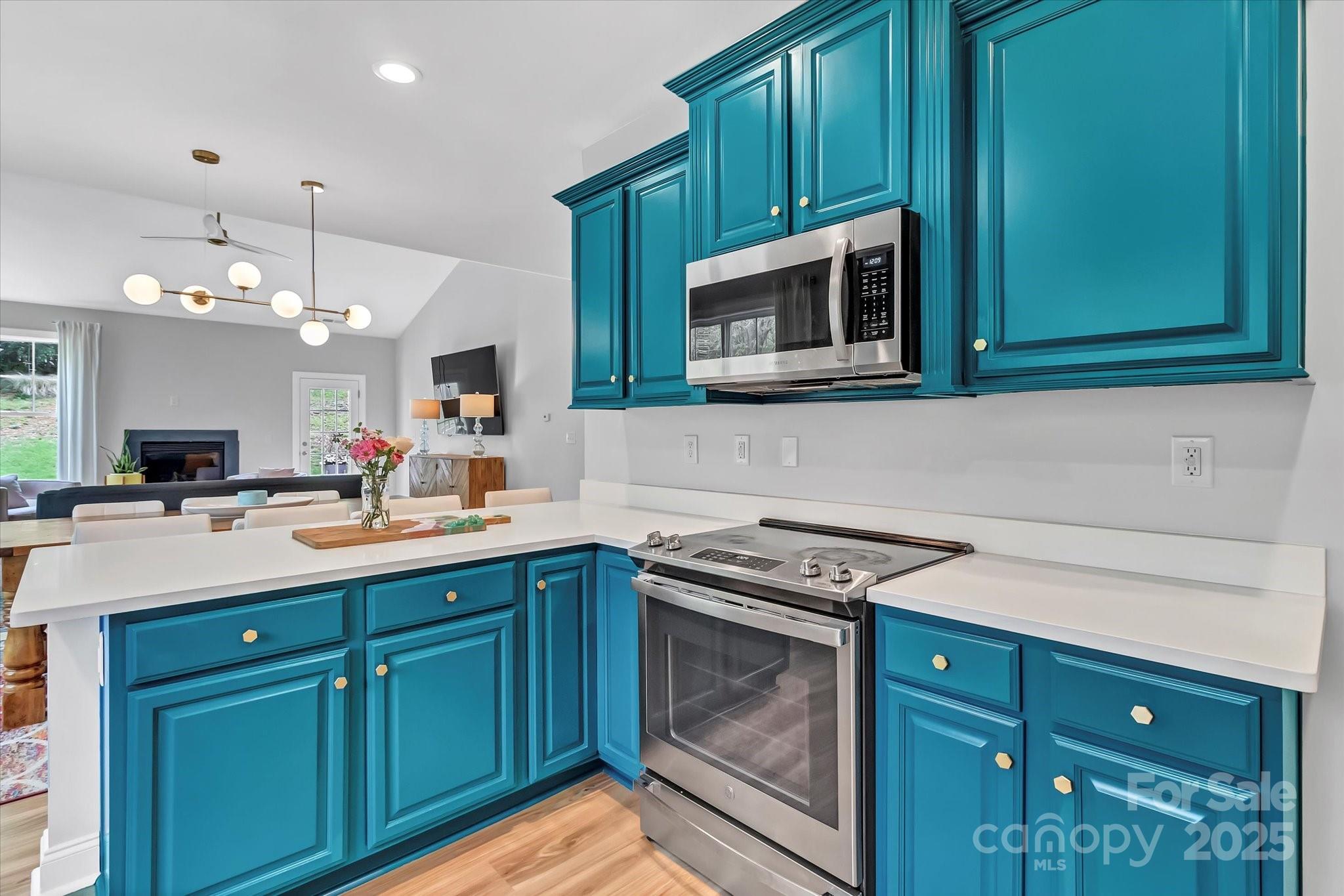 835 Ryans Place Fort Mill, SC 29715 - Photo 8 of 37 a kitchen with stainless steel appliances granite countertop a sink stove and microwave