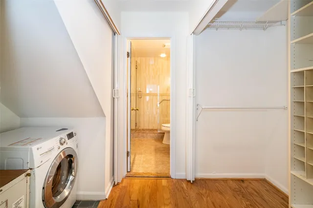 a view of walk in closet with empty racks