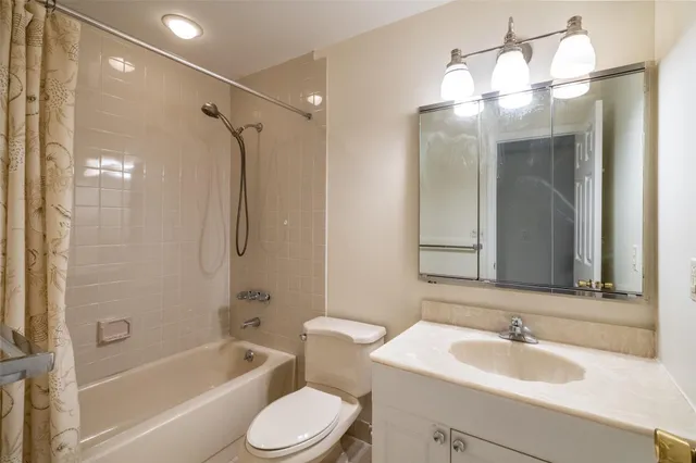 a bathroom with a sink toilet tub and shower