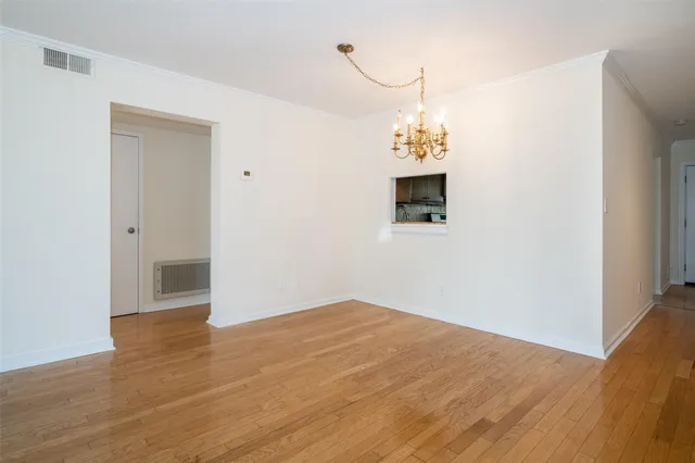 a view of a chandelier fan and wooden floor