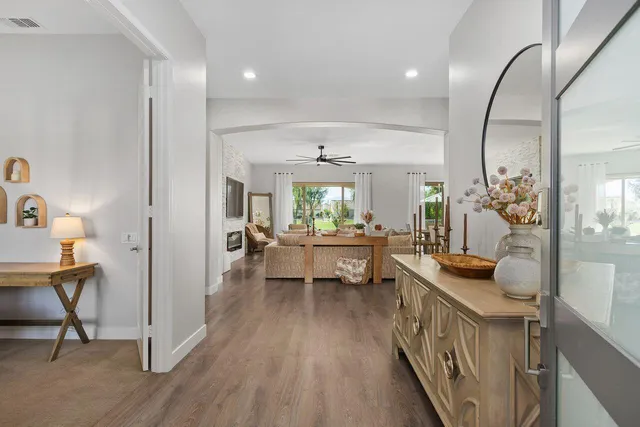a living room with furniture and a wooden floor