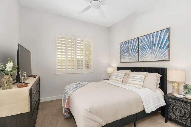 a bedroom with a large bed and a flat screen tv