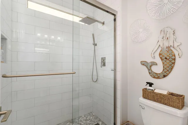 a bathroom with a shower a toilet and a shower