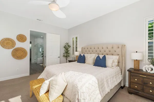 a bedroom with a bed and lamp