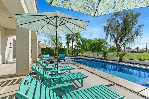 a view of a chair and tables in the balcony
