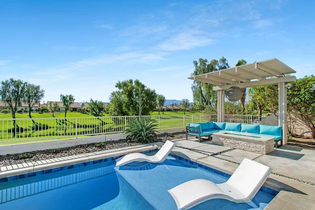 a view of a patio with chairs and a yard