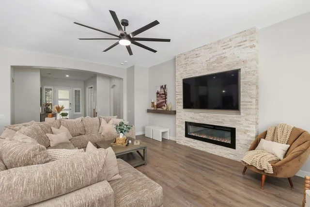 a living room with furniture fireplace and flat screen tv
