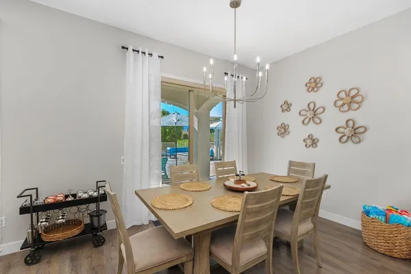 a view of a dining room with furniture and chandelier