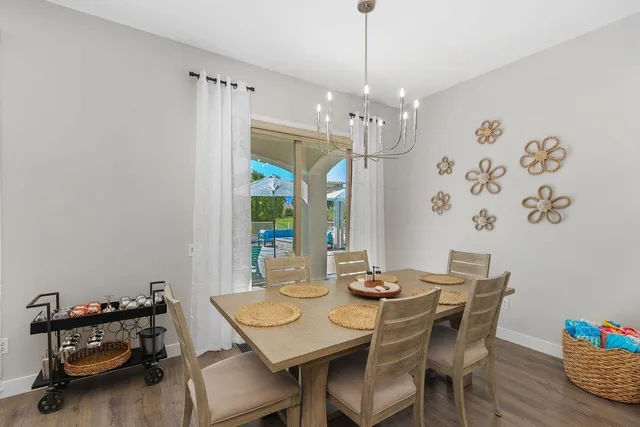 a view of a dining room with furniture and chandelier