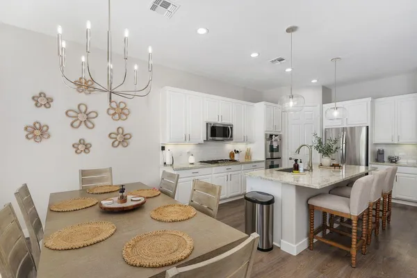 a kitchen with stainless steel appliances kitchen island granite countertop a sink and cabinets